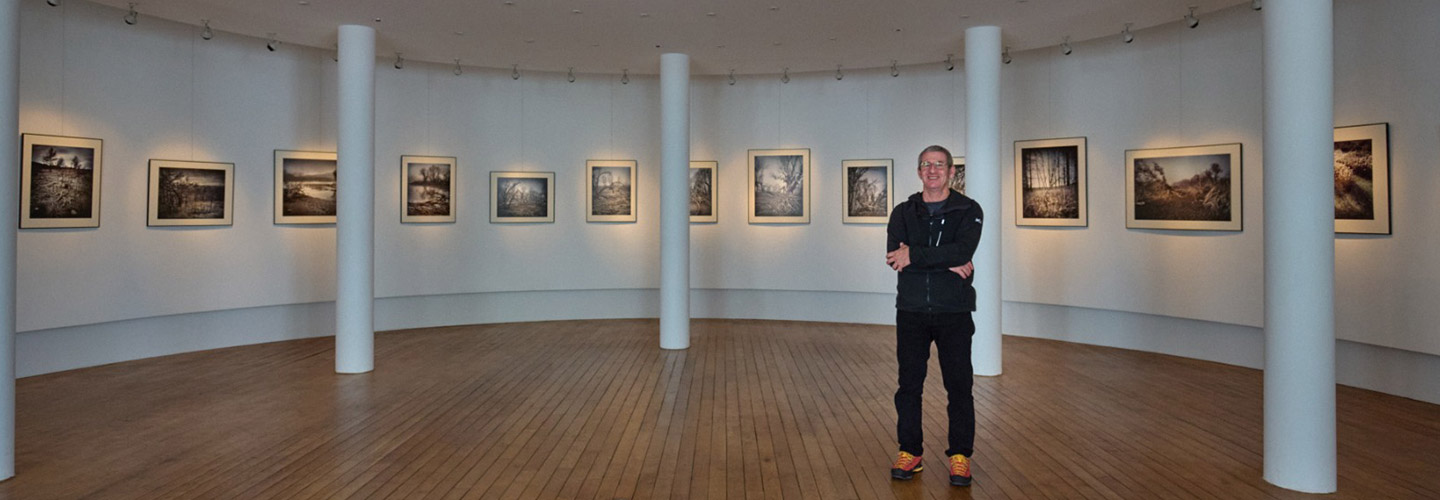 Abel Bourgeois, devant ses photographies exposées à La Rotonde